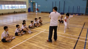 Coach teaching Fencers from Poi Ching School