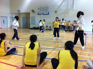 Students in School applying what they learnt in a fencing bout.